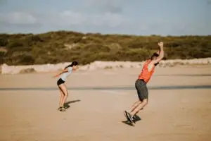 Two people exercise on the beach | Featured image for ACL Management.