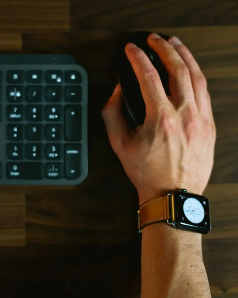 Person mousing in an office | Featured Image for Office Setup to Help with Wrist Pain