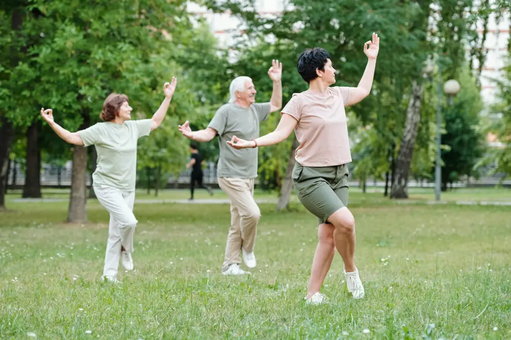 Group of three people execising outdoors | Featured image for the Blood Pressure Exercises page at Pivotal Motion Physiotherapy.